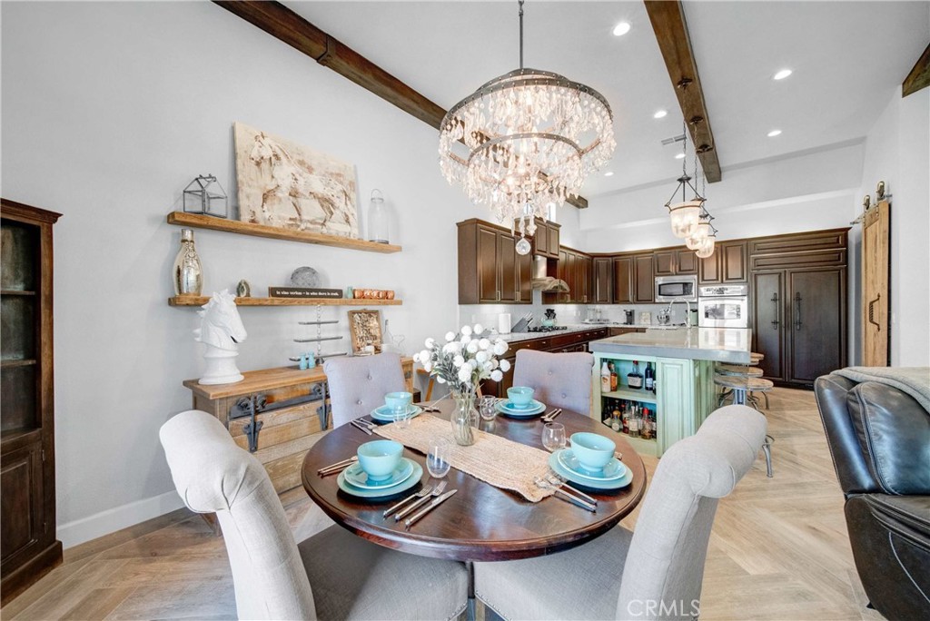 57721 Santa Rosa Trail La Quinta, CA 92253 - Photo 5 of 68 a view of a dining room with furniture a chandelier and wooden floor