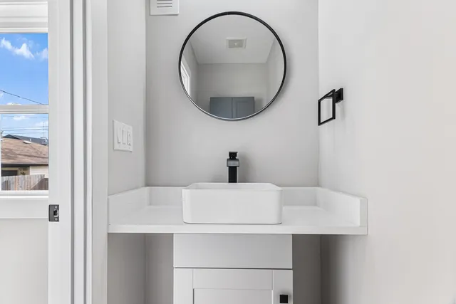 a white toilet sitting next to a shower