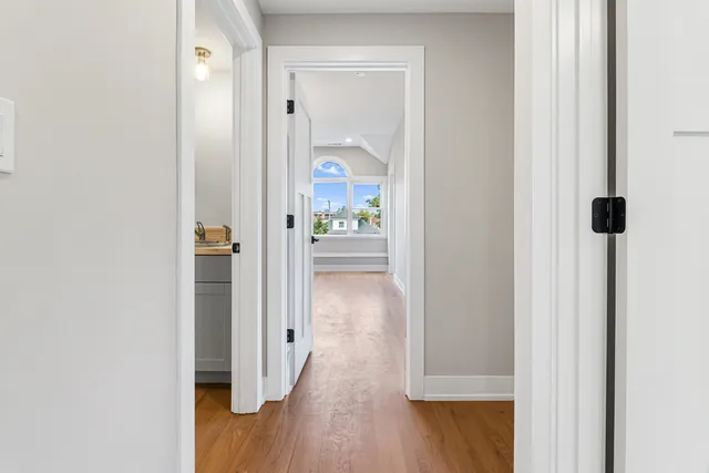 a view of room with window and wooden floor