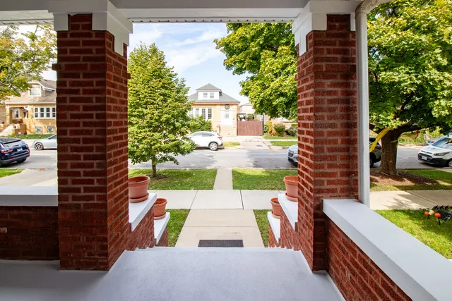 a view of a patio with table and chairs and potted plants