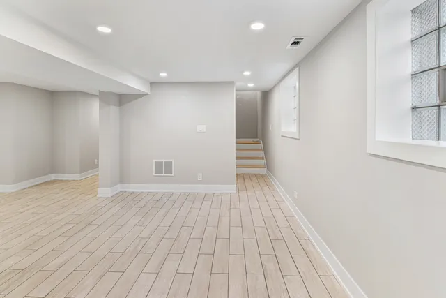a view of a hallway with wooden floor