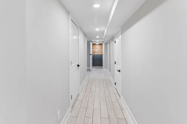 a bathroom with a toilet a sink a mirror and vanity