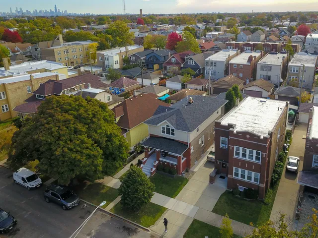 an aerial view of a house with a yard basket ball court and outdoor seating