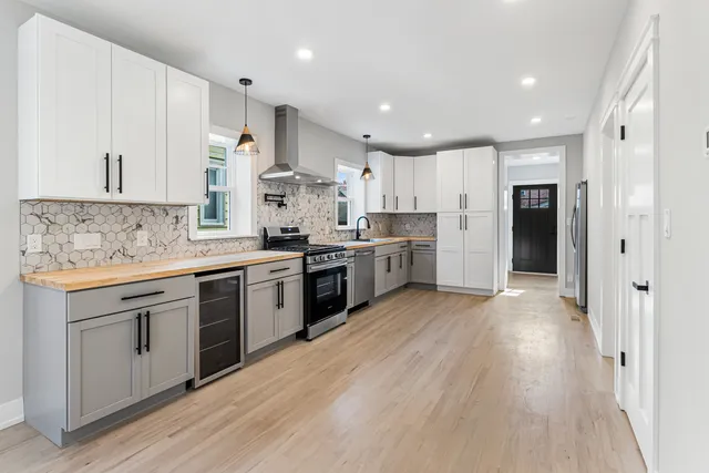 a kitchen with stainless steel appliances granite countertop a sink stove and refrigerator