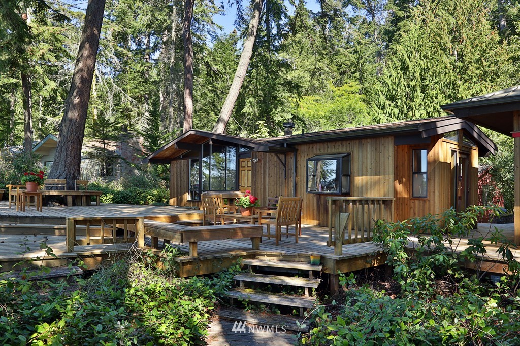 4576 South June Beach Road Freeland, WA 98249 - Photo 1 of 25 a view of a house with backyard sitting area and garden