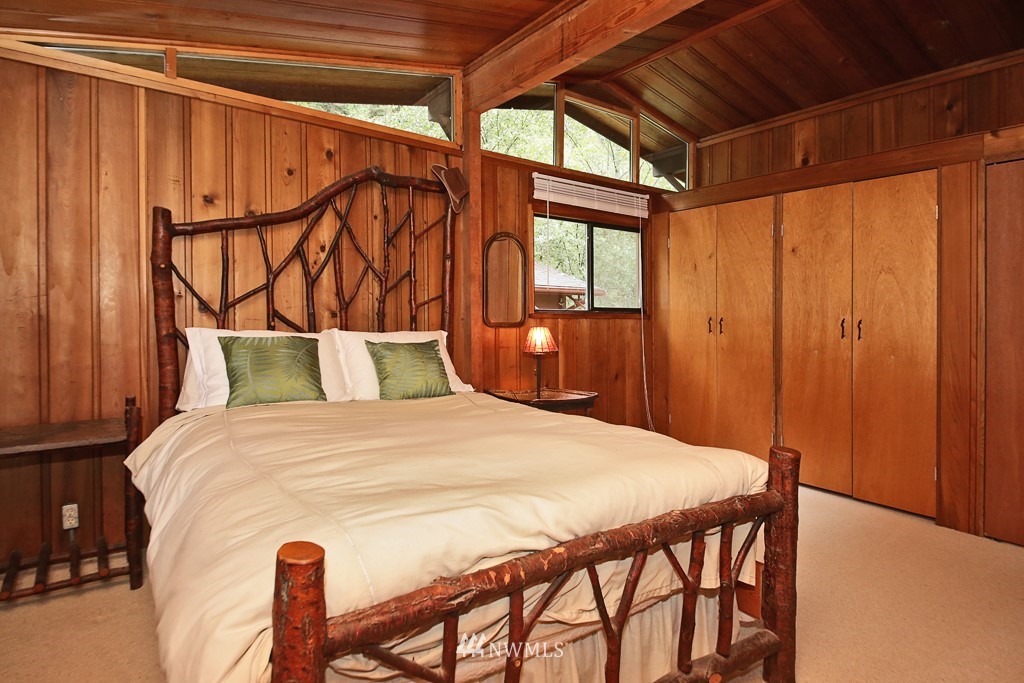 4576 South June Beach Road Freeland, WA 98249 - Photo 13 of 25 a bed sitting in a bedroom next to a window