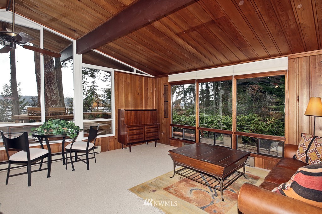 4576 South June Beach Road Freeland, WA 98249 - Photo 9 of 25 a living room with furniture and a floor to ceiling window