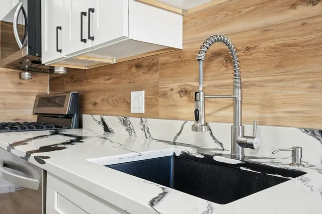 a kitchen with a sink and a stove