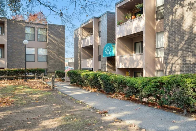 a front view of a building with a yard