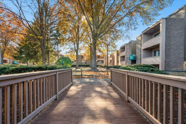 a view of a pathway with a wrought fence