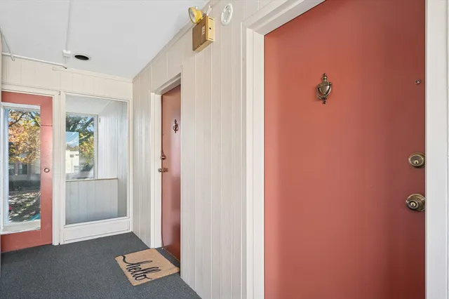 a view of an entryway with wooden floor