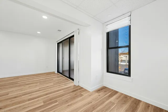 a view of an empty room with wooden floor