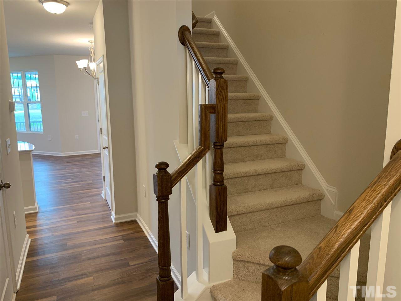 6102 Beale Loop, Unit 104 Raleigh, NC 27616 - Photo 2 of 29 a view of entryway and gallery with wooden floor