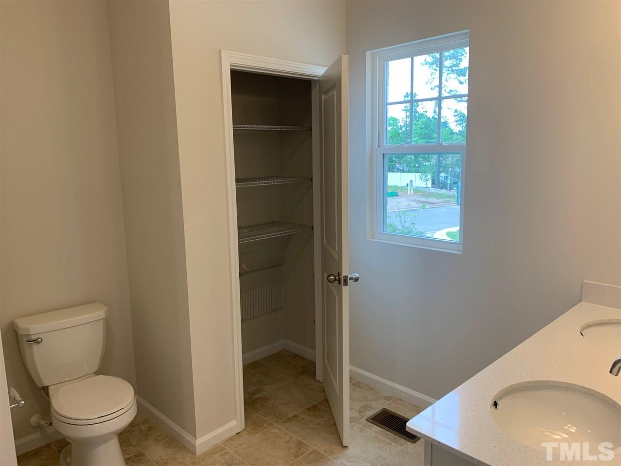 6102 Beale Loop, Unit 104 Raleigh, NC 27616 - Photo 15 of 29 a bathroom with a toilet and a sink