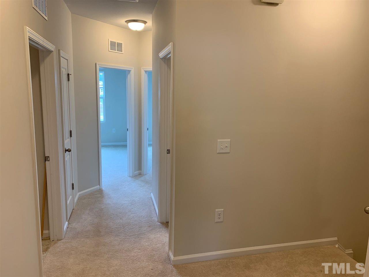 6102 Beale Loop, Unit 104 Raleigh, NC 27616 - Photo 16 of 29 a view of a hallway with closet area