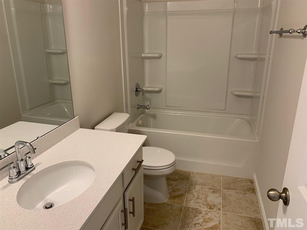 6102 Beale Loop, Unit 104 Raleigh, NC 27616 - Photo 19 of 29 a bathroom with a sink toilet and shower
