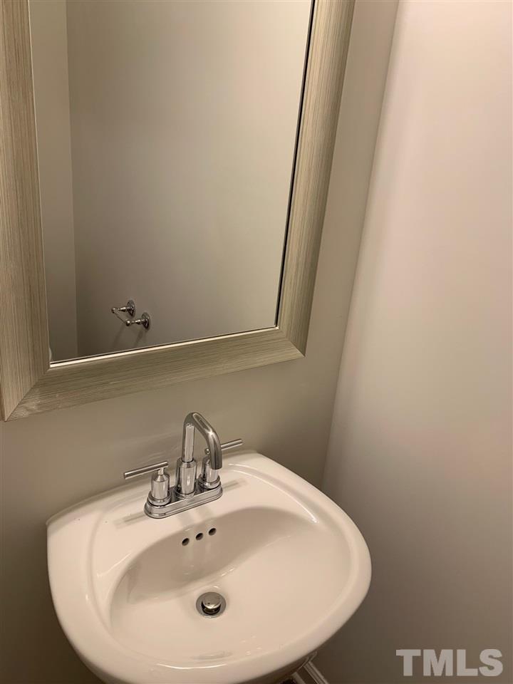 6102 Beale Loop, Unit 104 Raleigh, NC 27616 - Photo 21 of 29 a bathroom with a sink and a mirror