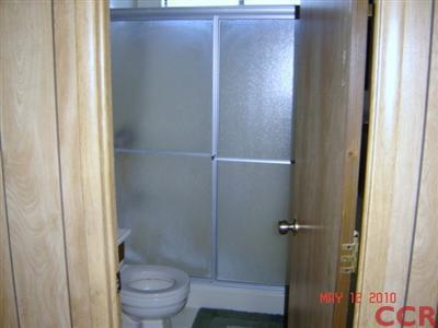 3860 Cherry Hill Road, Unit 136 Santa Maria, CA 93455 - Photo 5 of 14 a bathroom with a granite countertop sink toilet and a shower