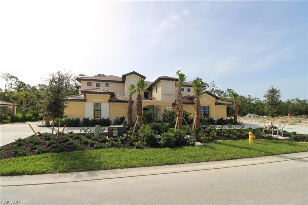 10539 Casella Way, Unit 202 Fort Myers, FL 33913 - Photo 1 of 28 a front view of a house with a yard and outdoor seating