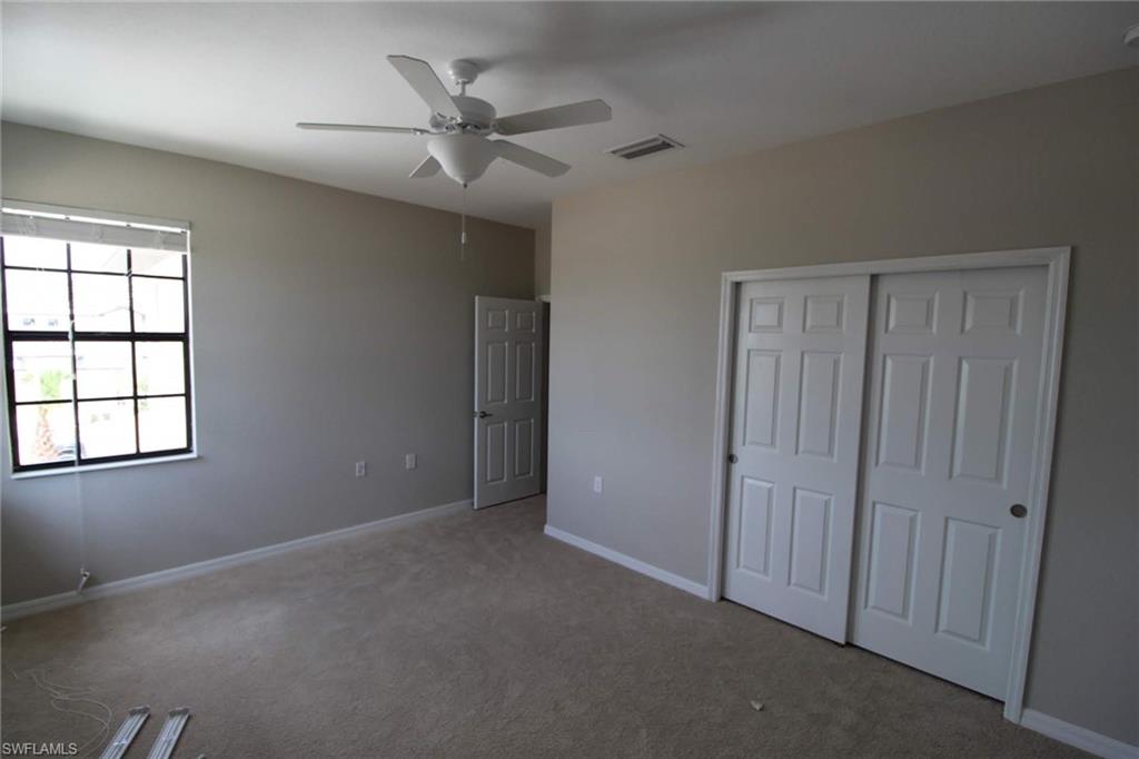 10539 Casella Way, Unit 202 Fort Myers, FL 33913 - Photo 11 of 28 an empty room with windows and fan