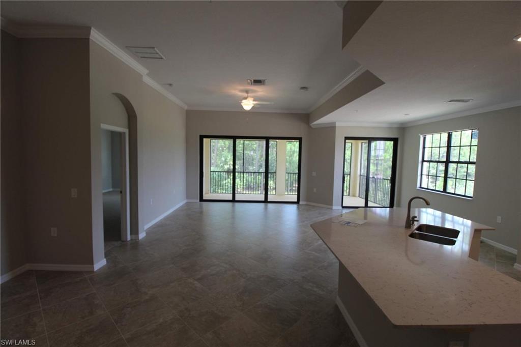 10539 Casella Way, Unit 202 Fort Myers, FL 33913 - Photo 12 of 28 a view of a livingroom with furniture wooden floor and windows
