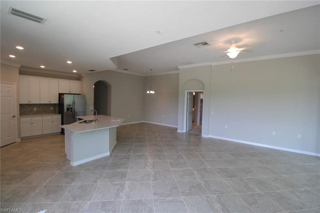 10539 Casella Way, Unit 202 Fort Myers, FL 33913 - Photo 15 of 28 a view of a kitchen with a sink and a refrigerator