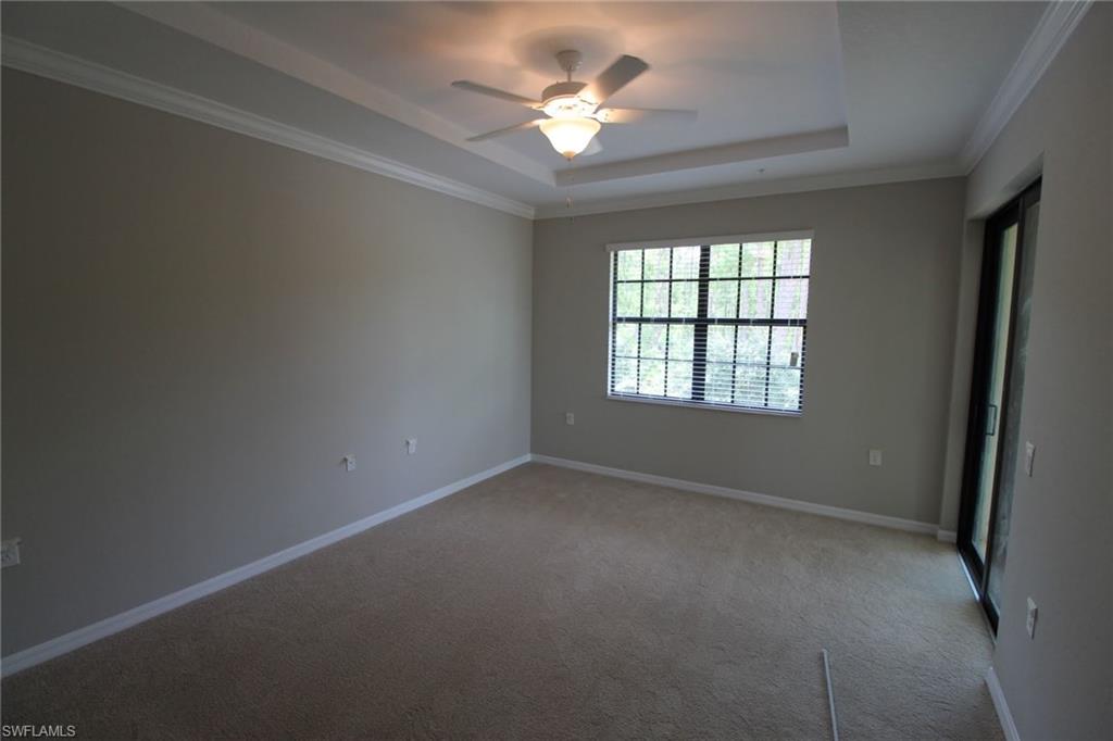 10539 Casella Way, Unit 202 Fort Myers, FL 33913 - Photo 18 of 28 an empty room with windows and ceiling fan