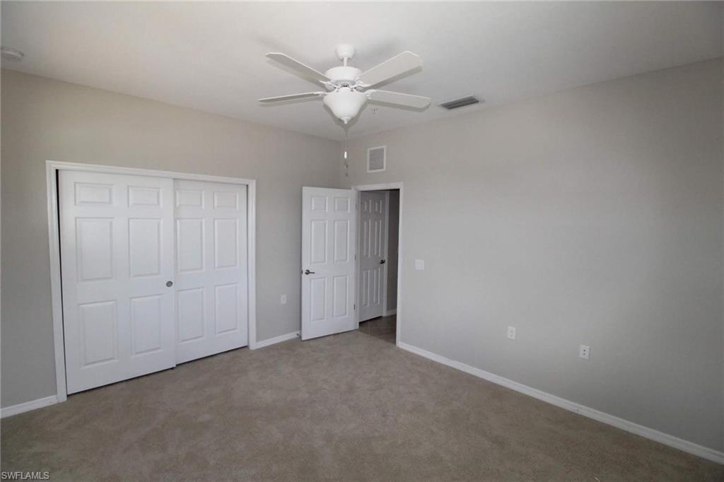 10539 Casella Way, Unit 202 Fort Myers, FL 33913 - Photo 8 of 28 an empty room with a ceiling fan and a window