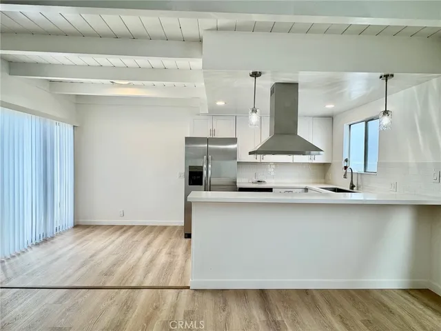 a kitchen with stainless steel appliances a sink and cabinets