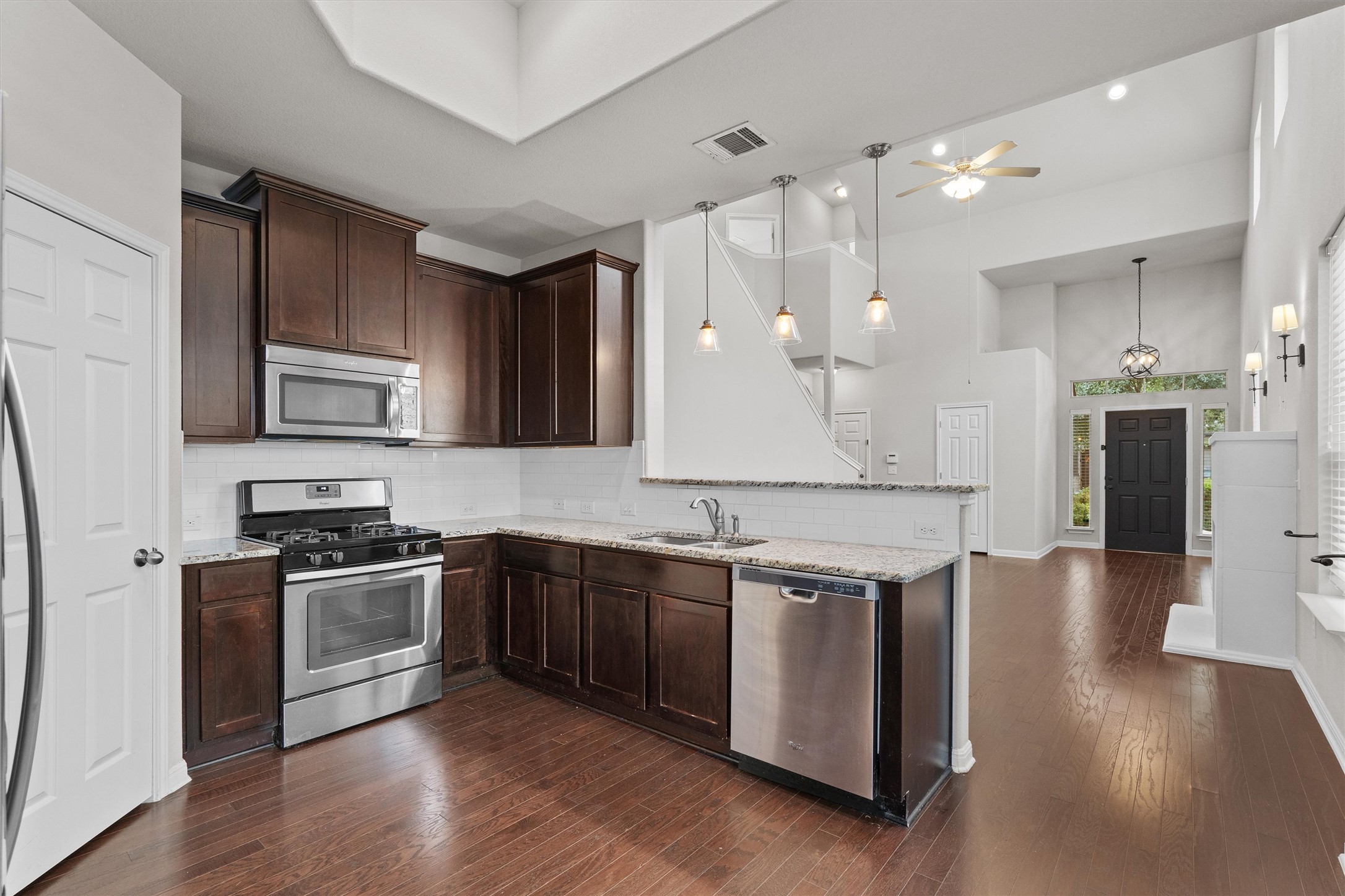 7709 Menchaca Road, Unit 22 Austin, TX 78745 - Photo 11 of 35 a large kitchen with stainless steel appliances granite countertop a stove and a sink