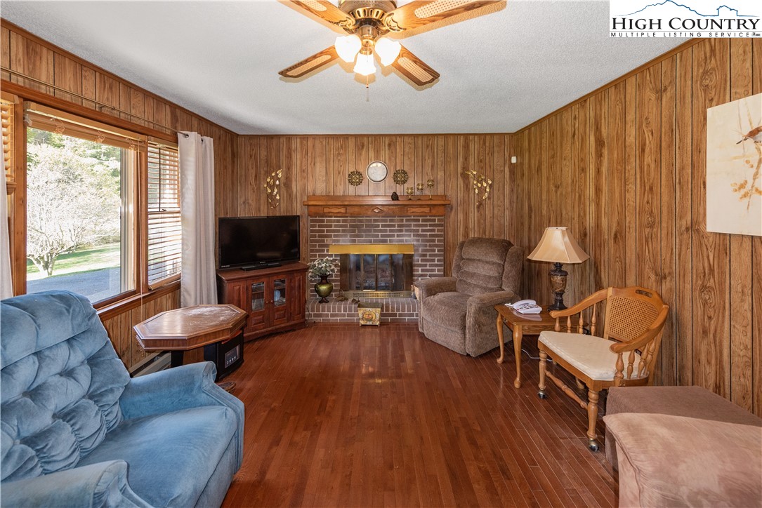 4934 Silas Creek Road Lansing, NC 28643 - Photo 15 of 32 a living room with furniture and a flat screen tv