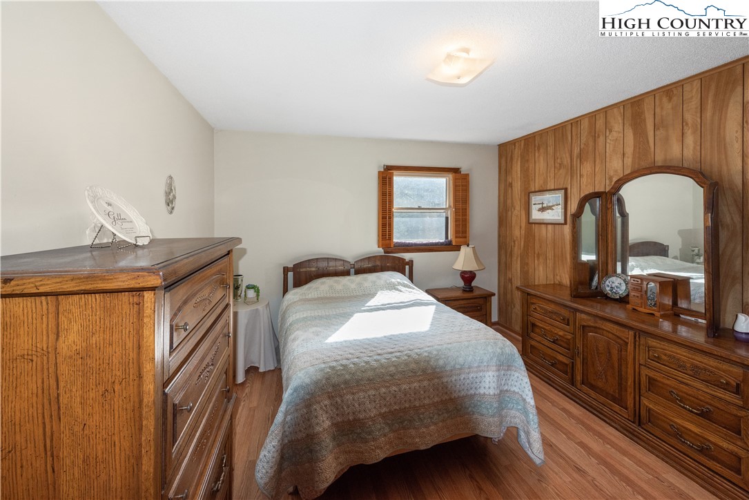 4934 Silas Creek Road Lansing, NC 28643 - Photo 23 of 32 a bedroom with a bed a dresser and mirror