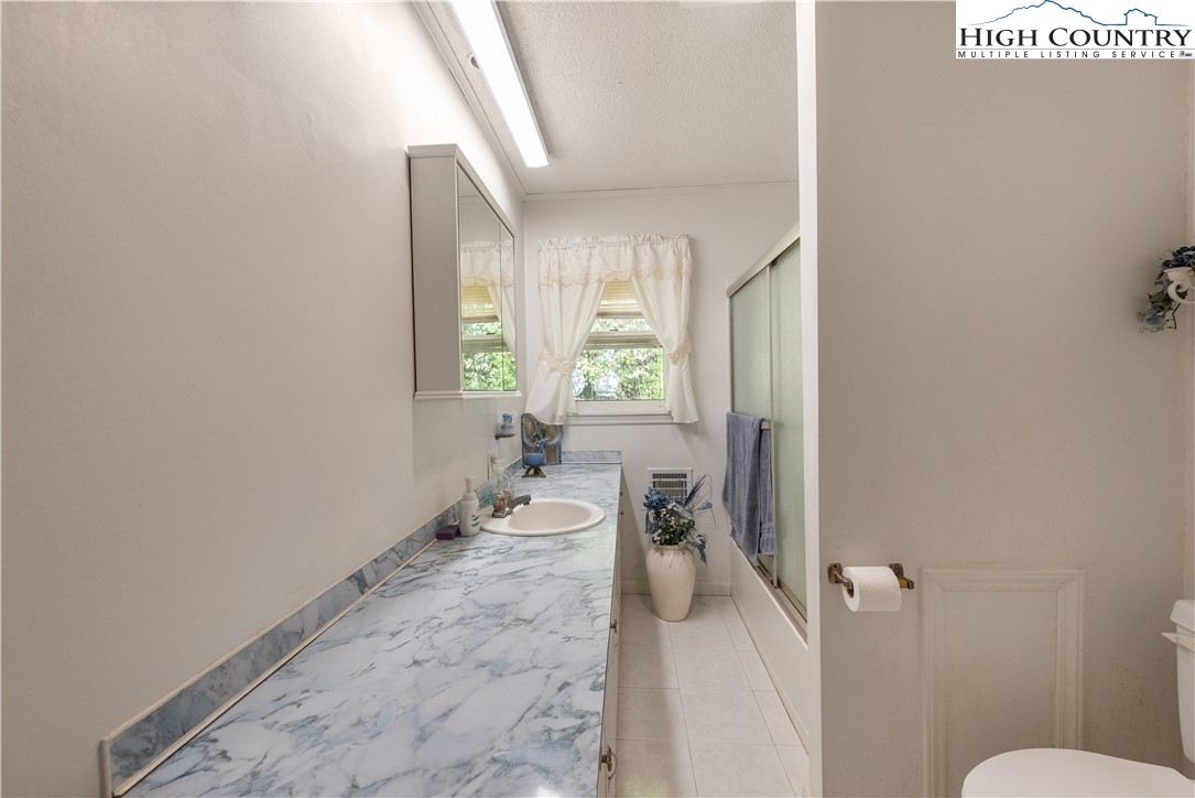 4934 Silas Creek Road Lansing, NC 28643 - Photo 27 of 32 a very nice looking room with a large window