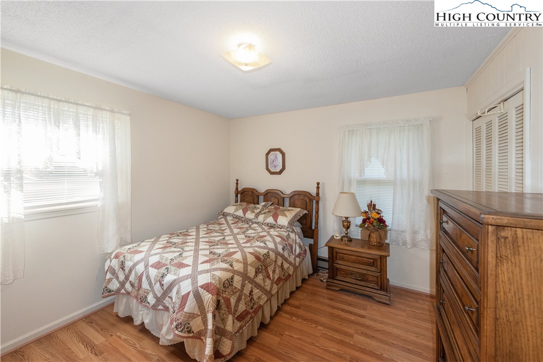 4934 Silas Creek Road Lansing, NC 28643 - Photo 29 of 32 a bed sitting in a bedroom next to a window