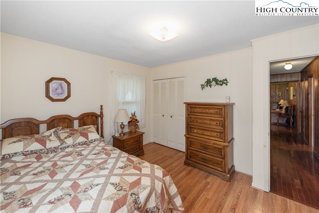 4934 Silas Creek Road Lansing, NC 28643 - Photo 30 of 32 a bedroom with a bed and a dresser