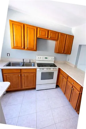 a kitchen with stainless steel appliances a stove a sink and a microwave