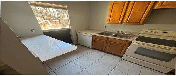 a kitchen with a stove window and cabinets