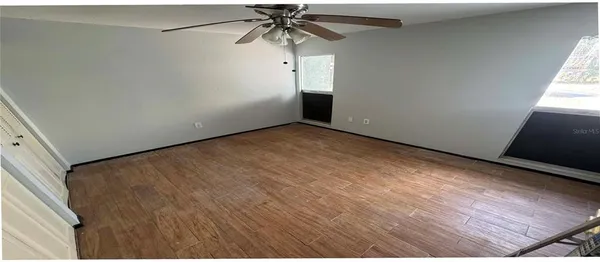 a view of a room with window and a ceiling fan