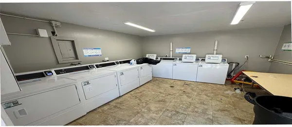 a kitchen with sink refrigerator and couches