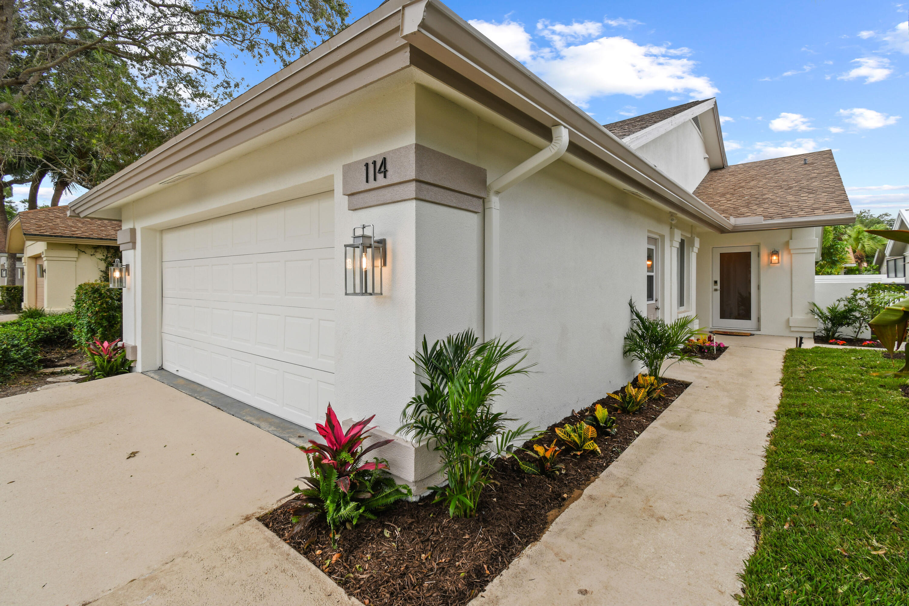 114 Inner Harbour Way Jupiter, FL 33477 - Photo 1 of 38 a front view of a house with a yard