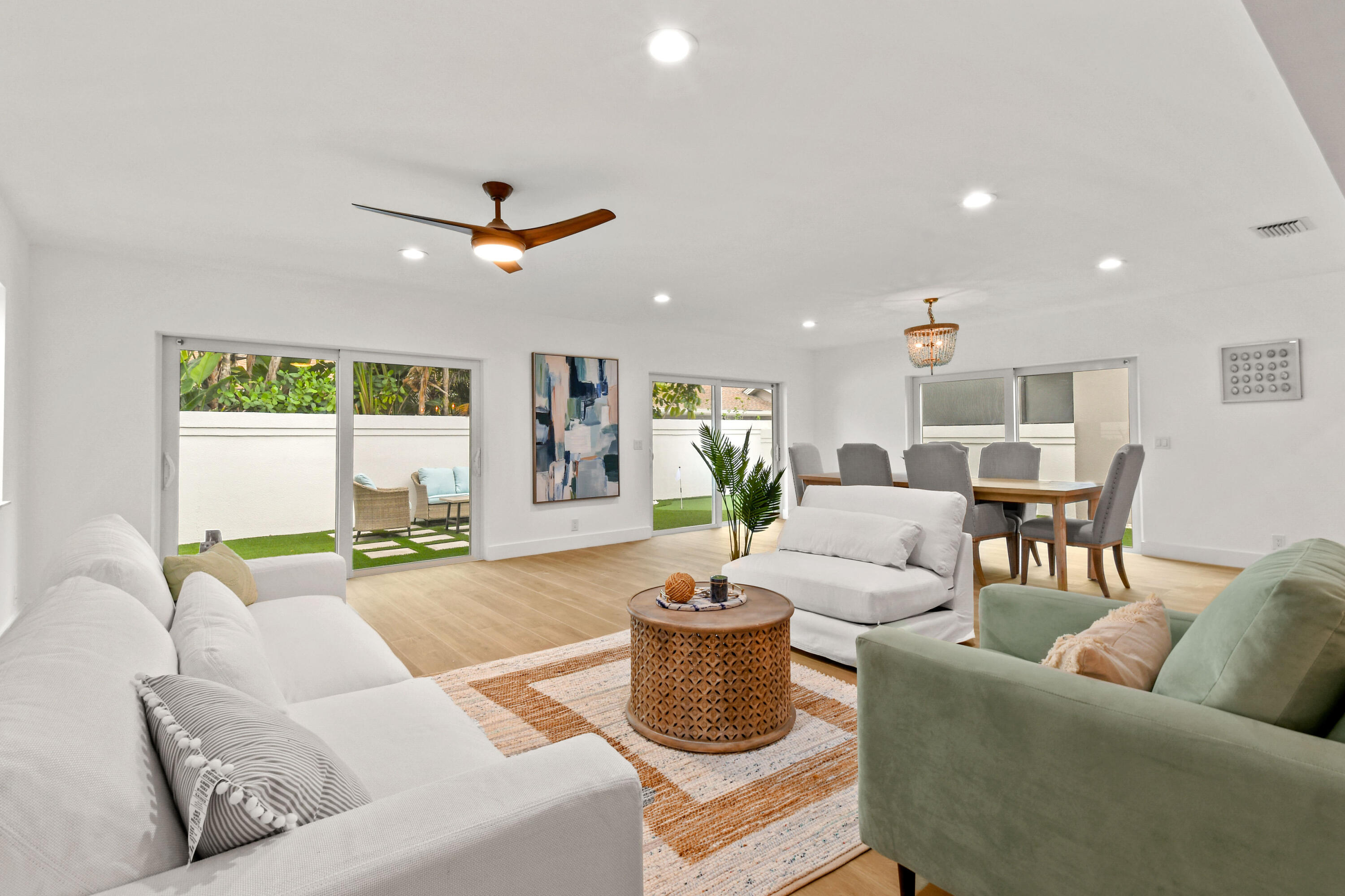 114 Inner Harbour Way Jupiter, FL 33477 - Photo 12 of 38 a living room with furniture a ceiling fan and a window