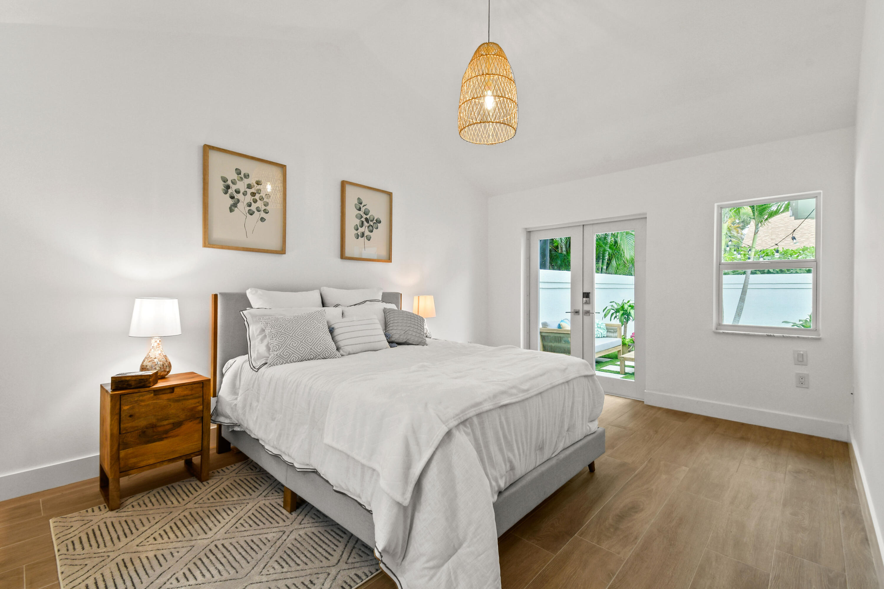 114 Inner Harbour Way Jupiter, FL 33477 - Photo 16 of 38 a bedroom with a bed and a chandelier