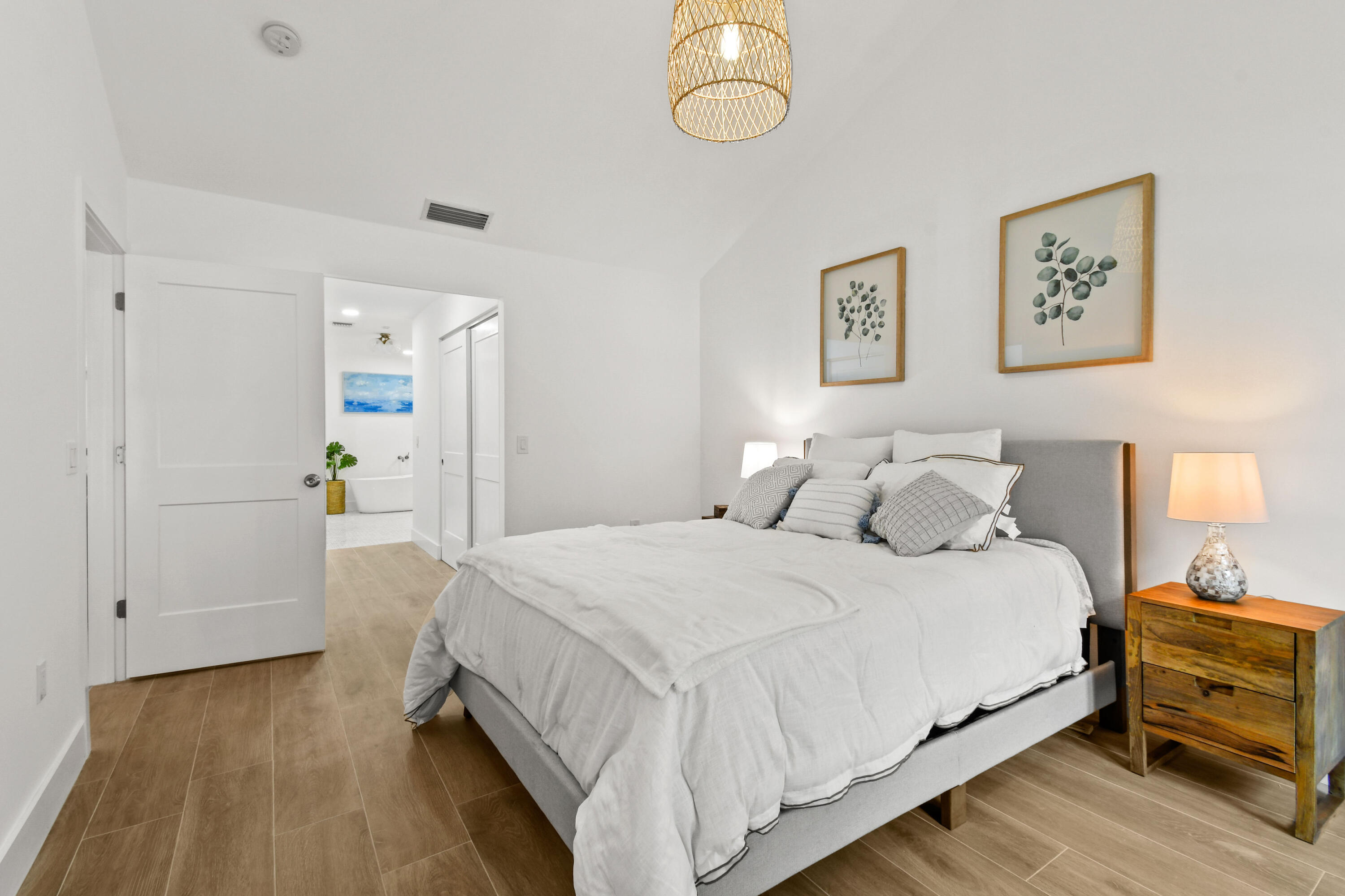 114 Inner Harbour Way Jupiter, FL 33477 - Photo 18 of 38 a bedroom with a bed and a lamp on dresser