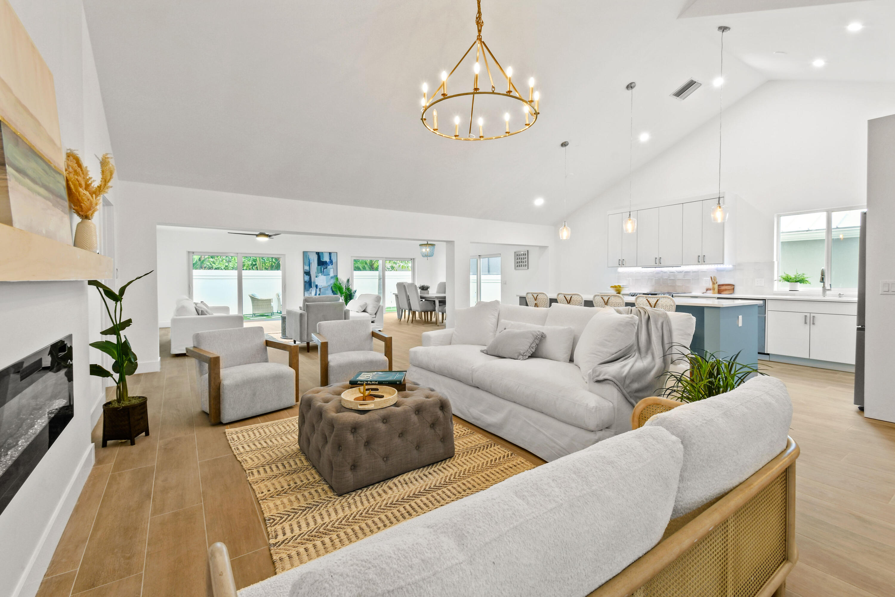 114 Inner Harbour Way Jupiter, FL 33477 - Photo 3 of 38 a living room with furniture kitchen view and a chandelier