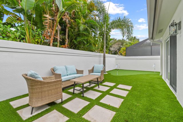 a backyard of a house with table and chairs