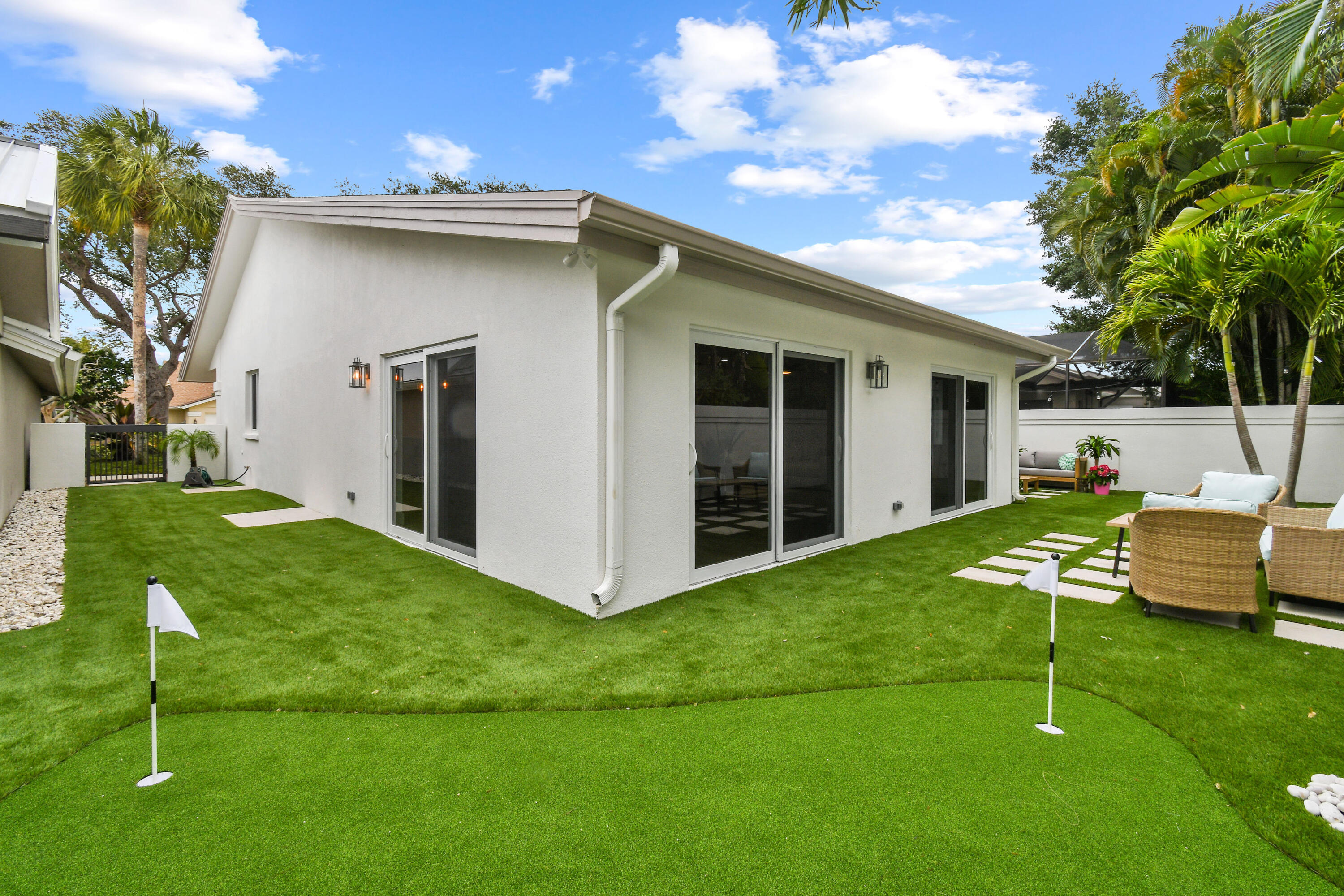 114 Inner Harbour Way Jupiter, FL 33477 - Photo 34 of 38 a view of a house with backyard and sitting area