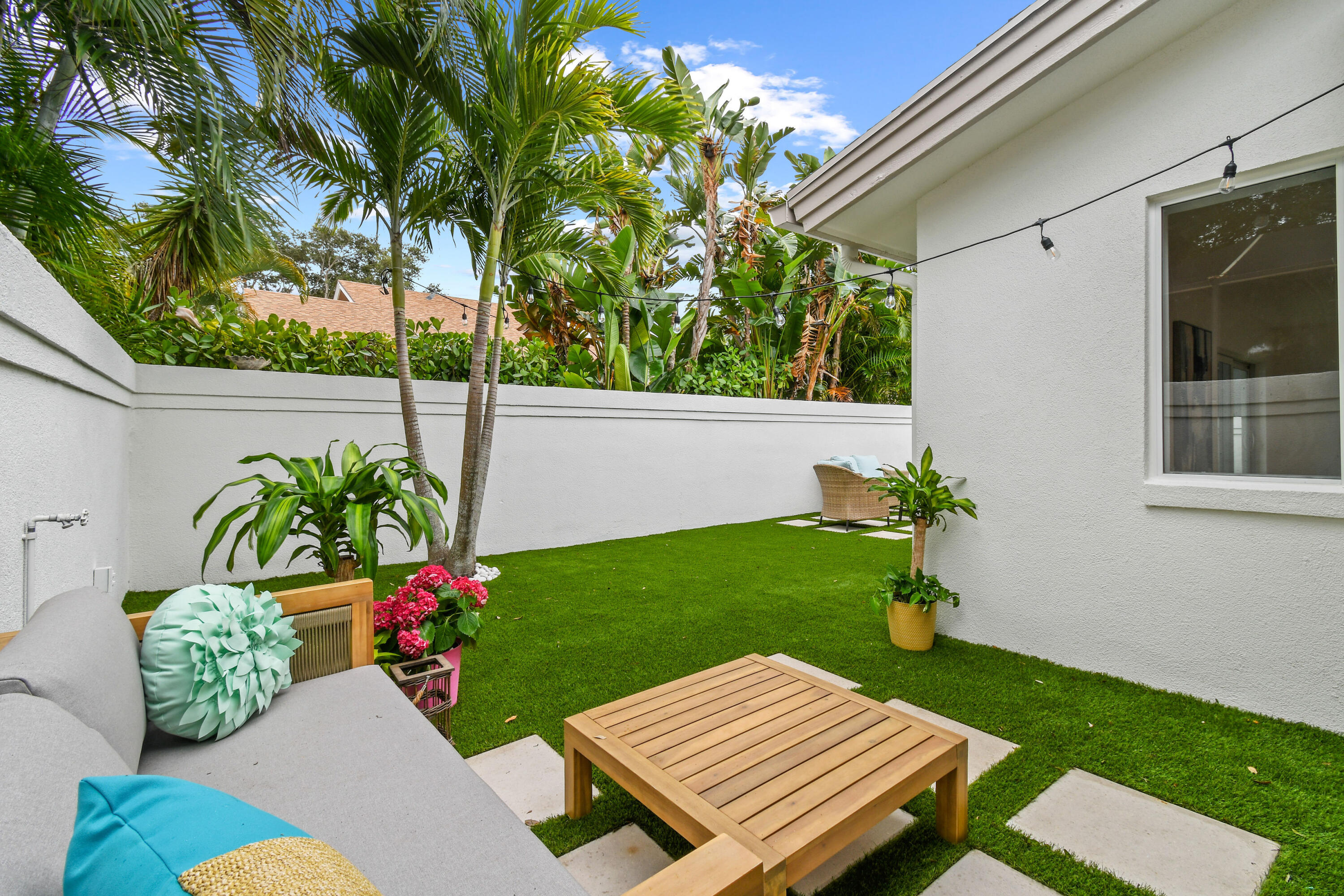 114 Inner Harbour Way Jupiter, FL 33477 - Photo 35 of 38 a view of a backyard with couches chair and a table