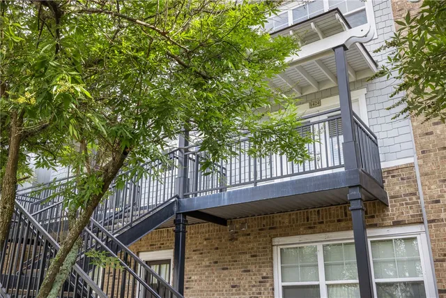 a view of a car parked in front of a brick house