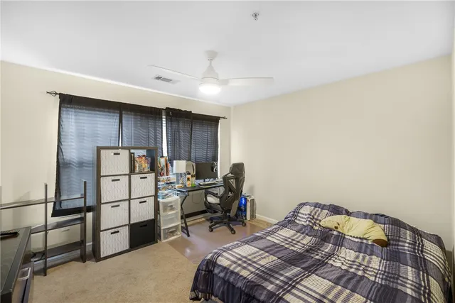 a bathroom with a sink a toilet a mirror and shower curtain