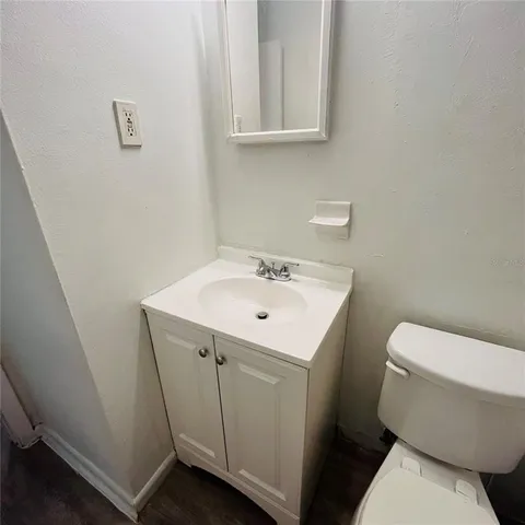 a white toilet sitting next to a bathroom sink